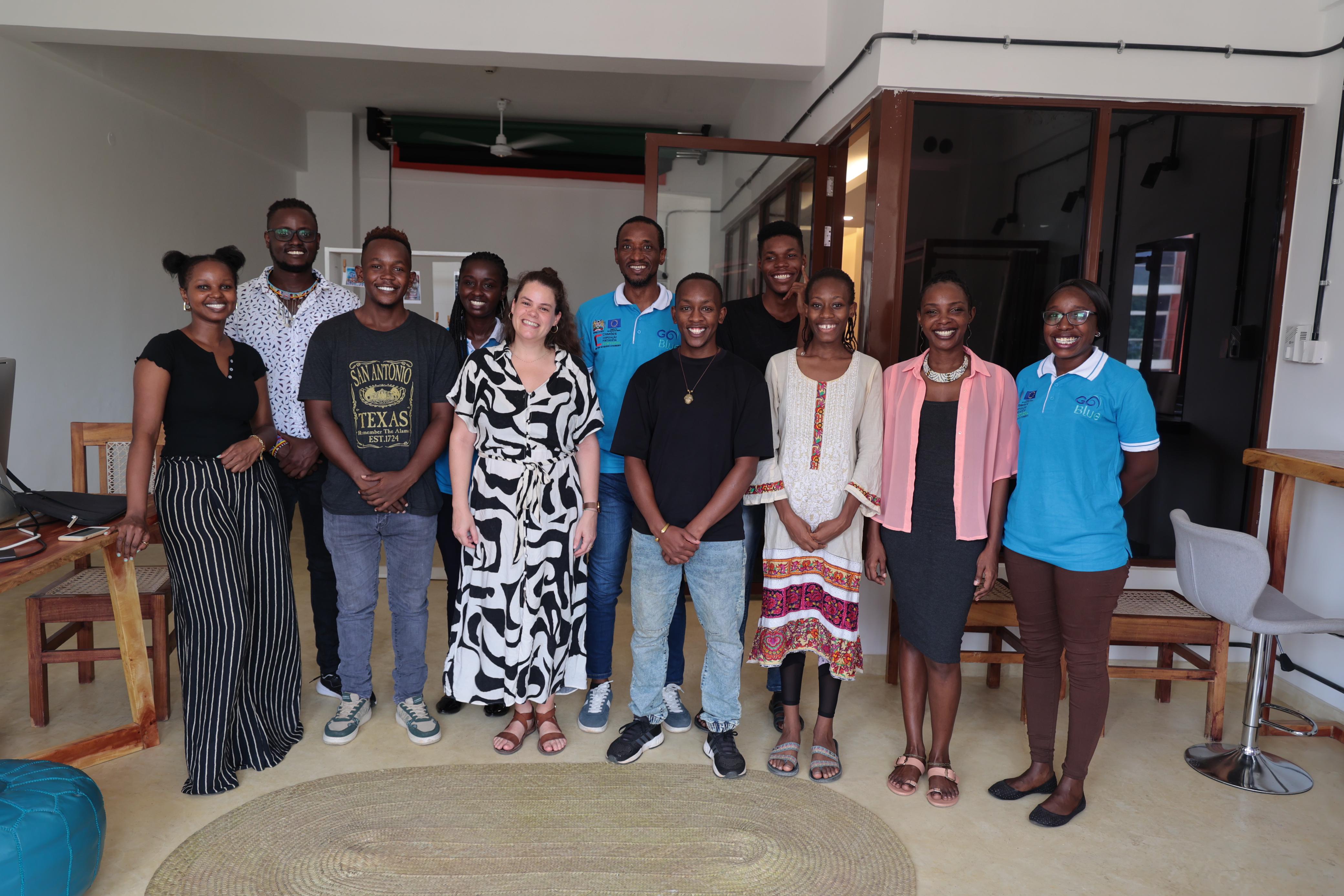 The team posing for a picture with one of the beneficiaries